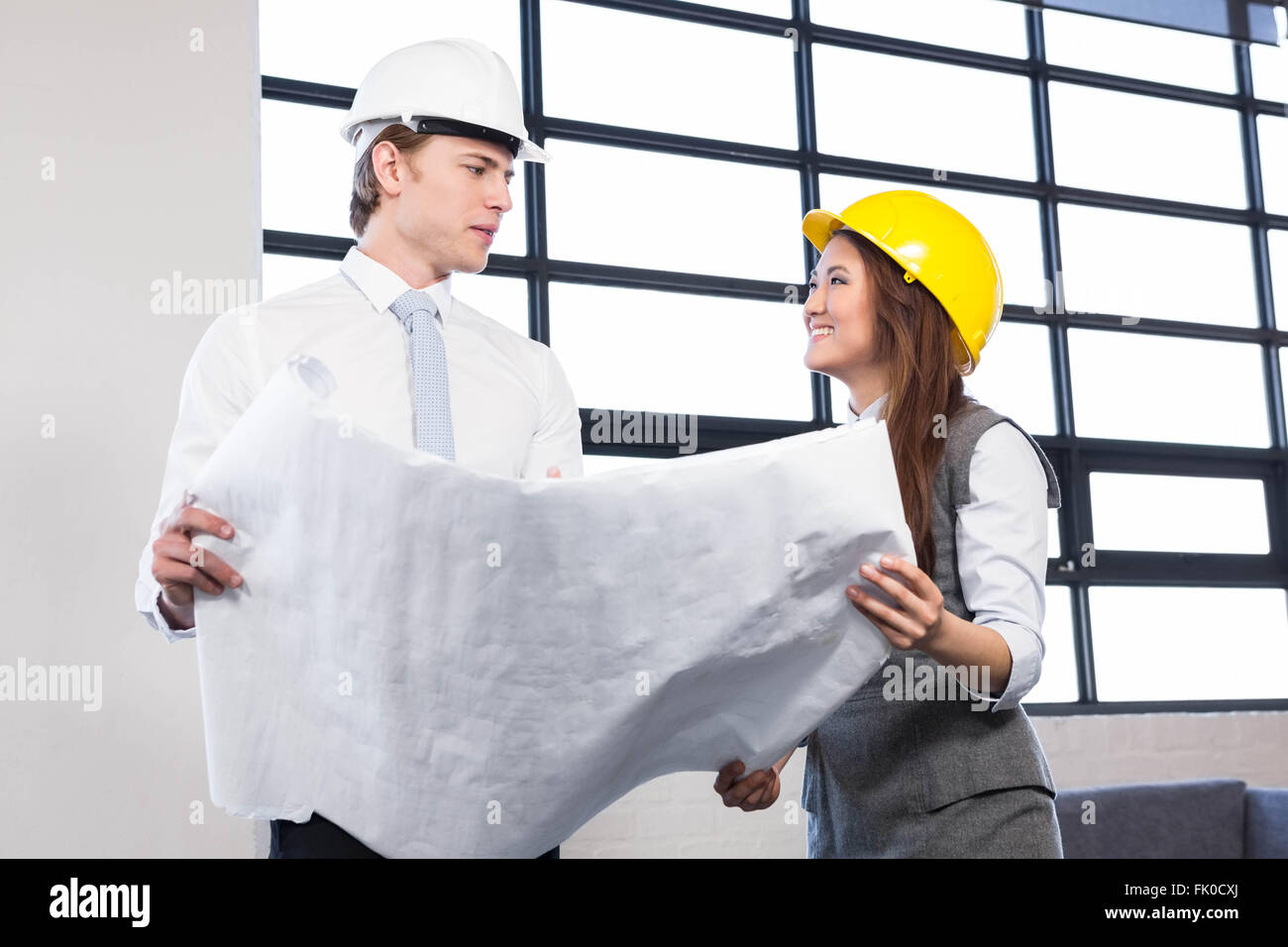 Architects Looking At Blueprint Stock Photo Alamy Architects Looking At Blueprint Stock Photo Alamy