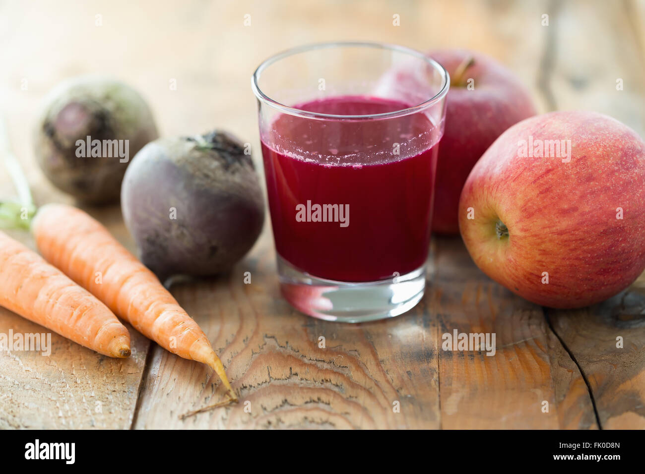 Glass of fresh beetroot apple and carrot juice on wooden table Stock Photo Alamy