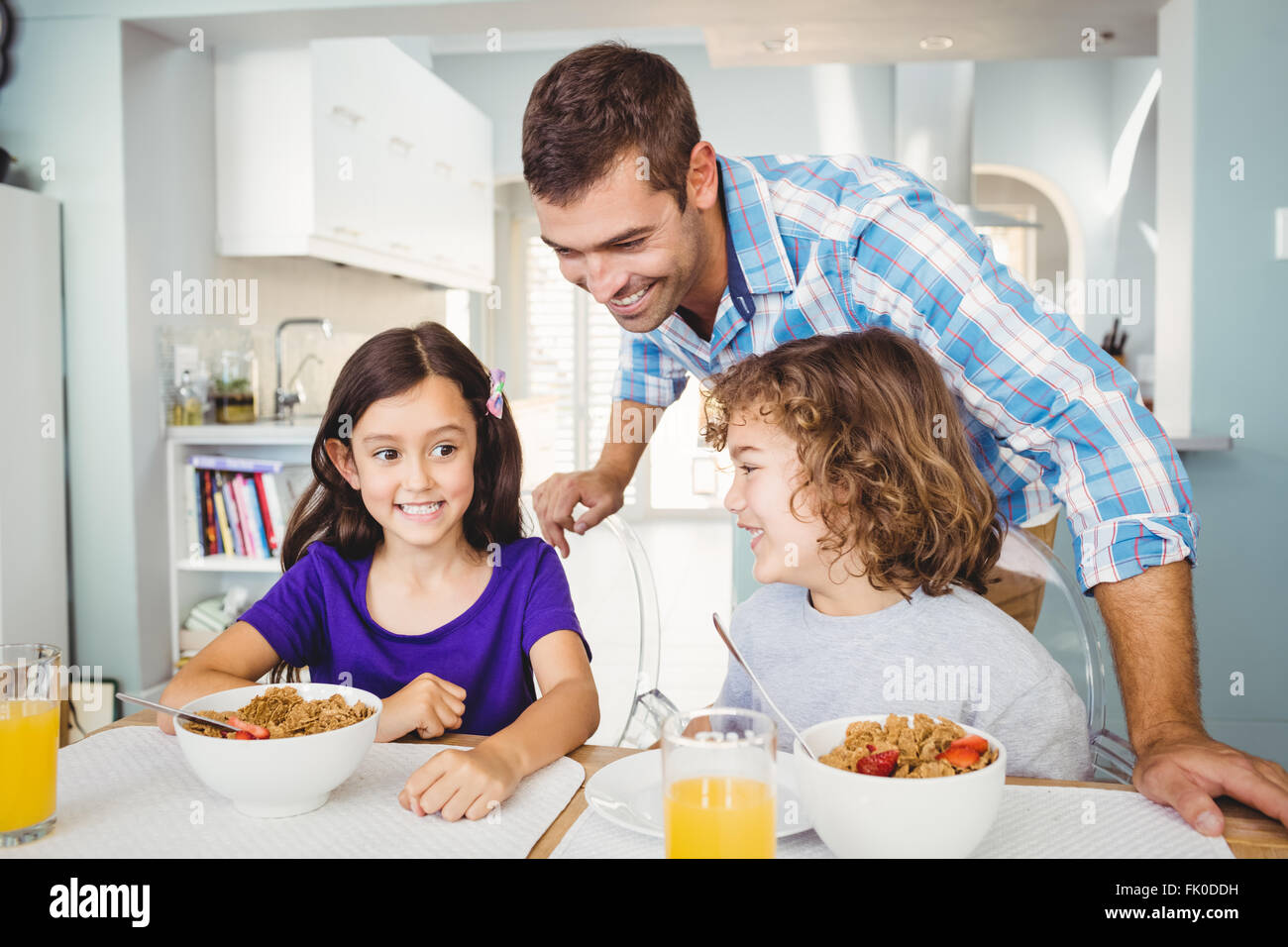 Happy man with children having breakfast Stock Photo