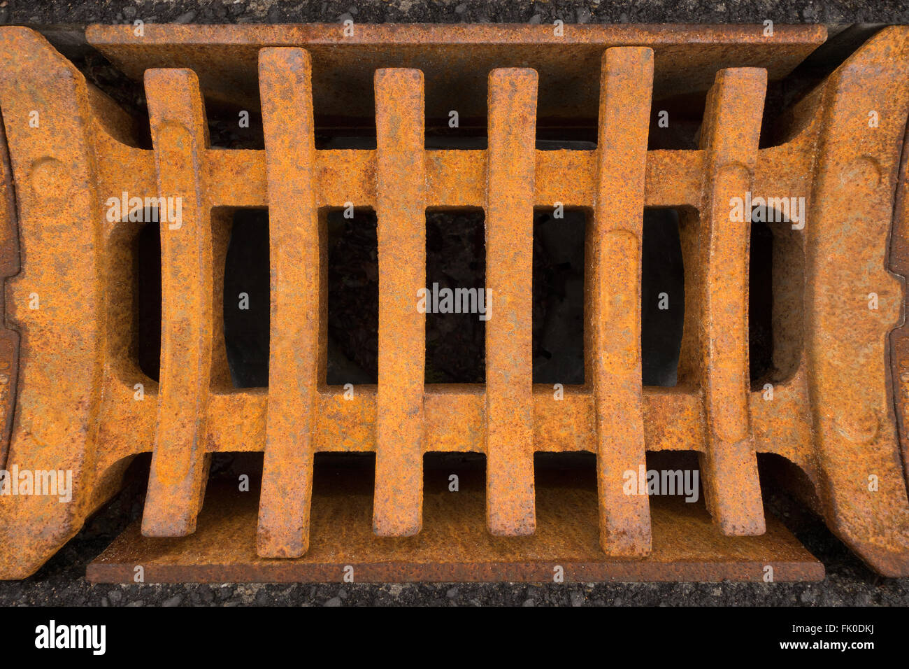 Rusty square grid of a storm drain in close-up Stock Photo