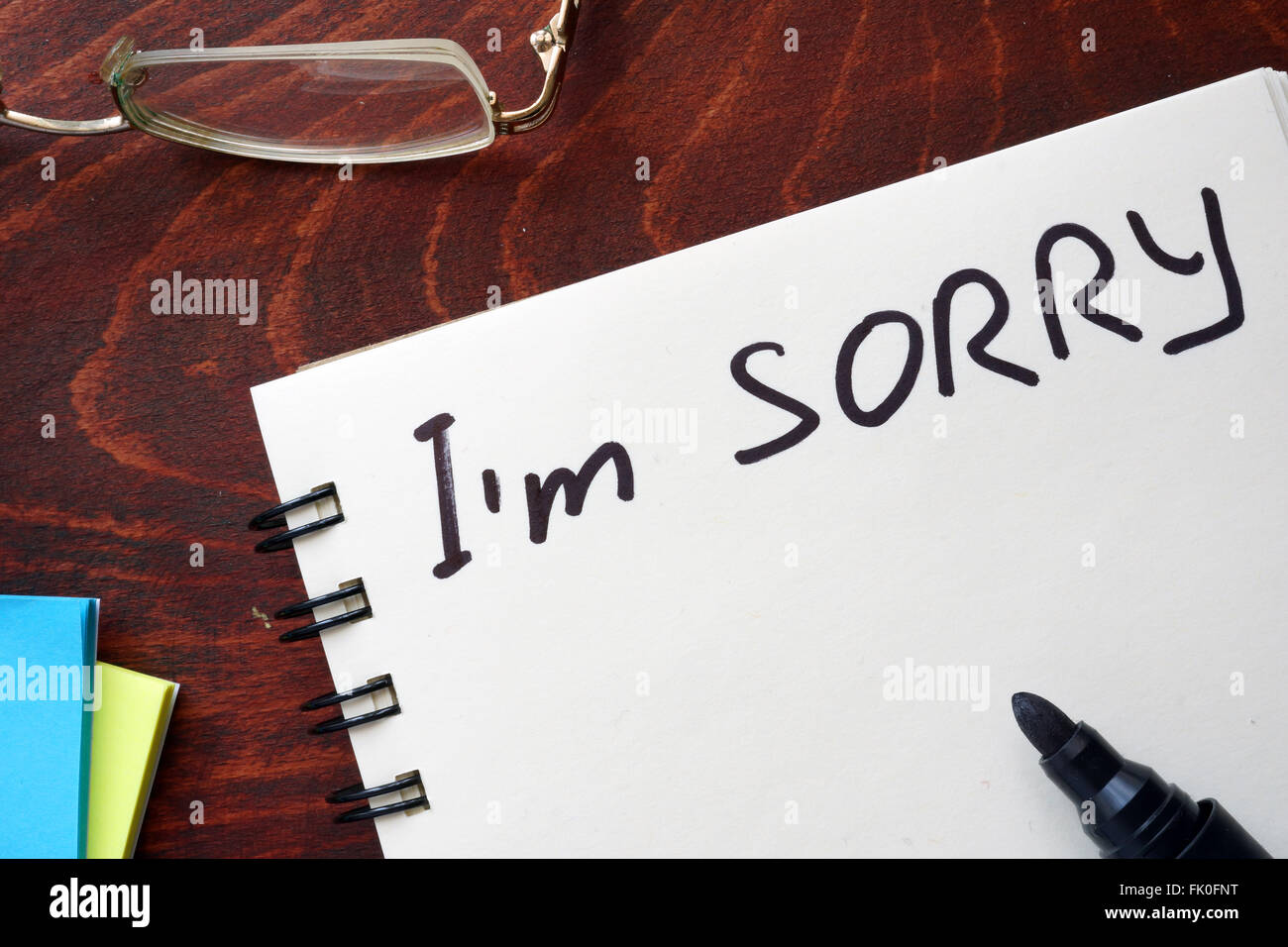 I am sorry written on notepad on a table. Stock Photo