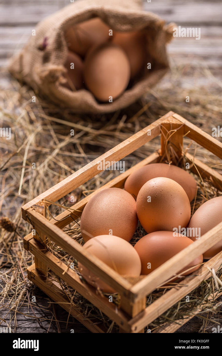 Bunch of fresh brown eggs in a wooden crate Stock Photo