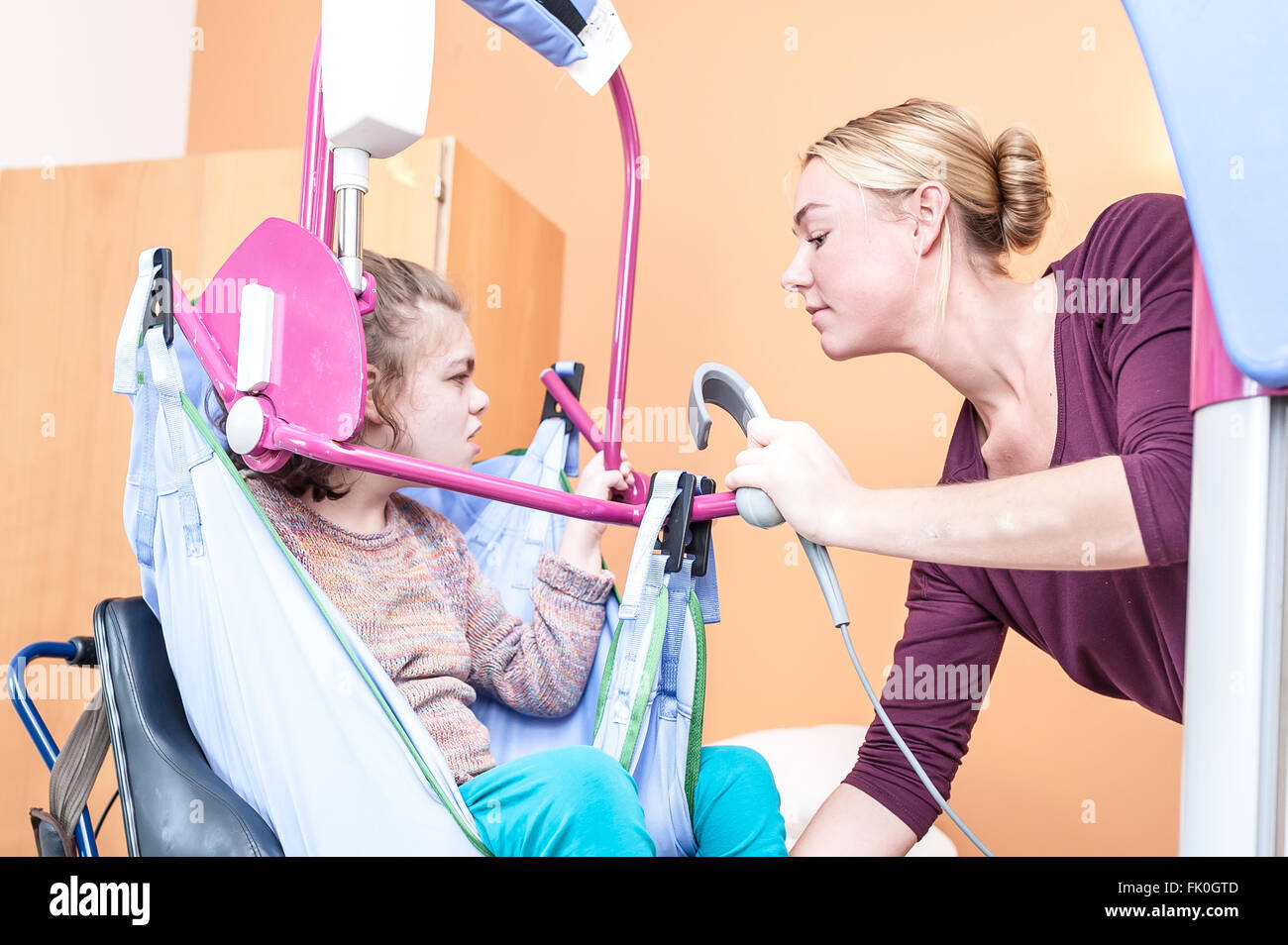 A disabled child in a wheelchair being cared for by a voluntary care