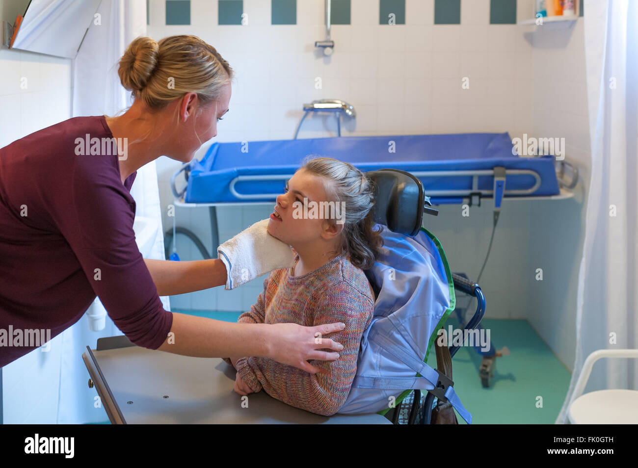 A Disabled Child In A Wheelchair Being Cared For By A Voluntary Care Worker Stock Photo Alamy
