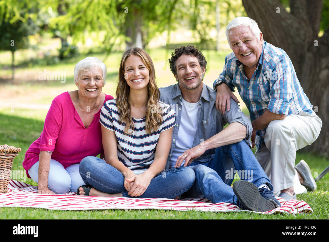 Smiling family sitting on a blanket Stock Photo