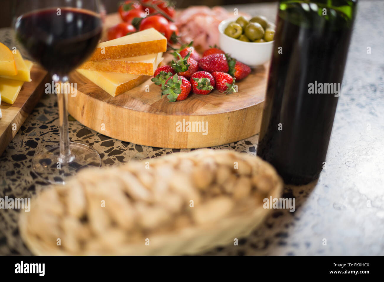 Wine bottle with a glass and a buch of food Stock Photo