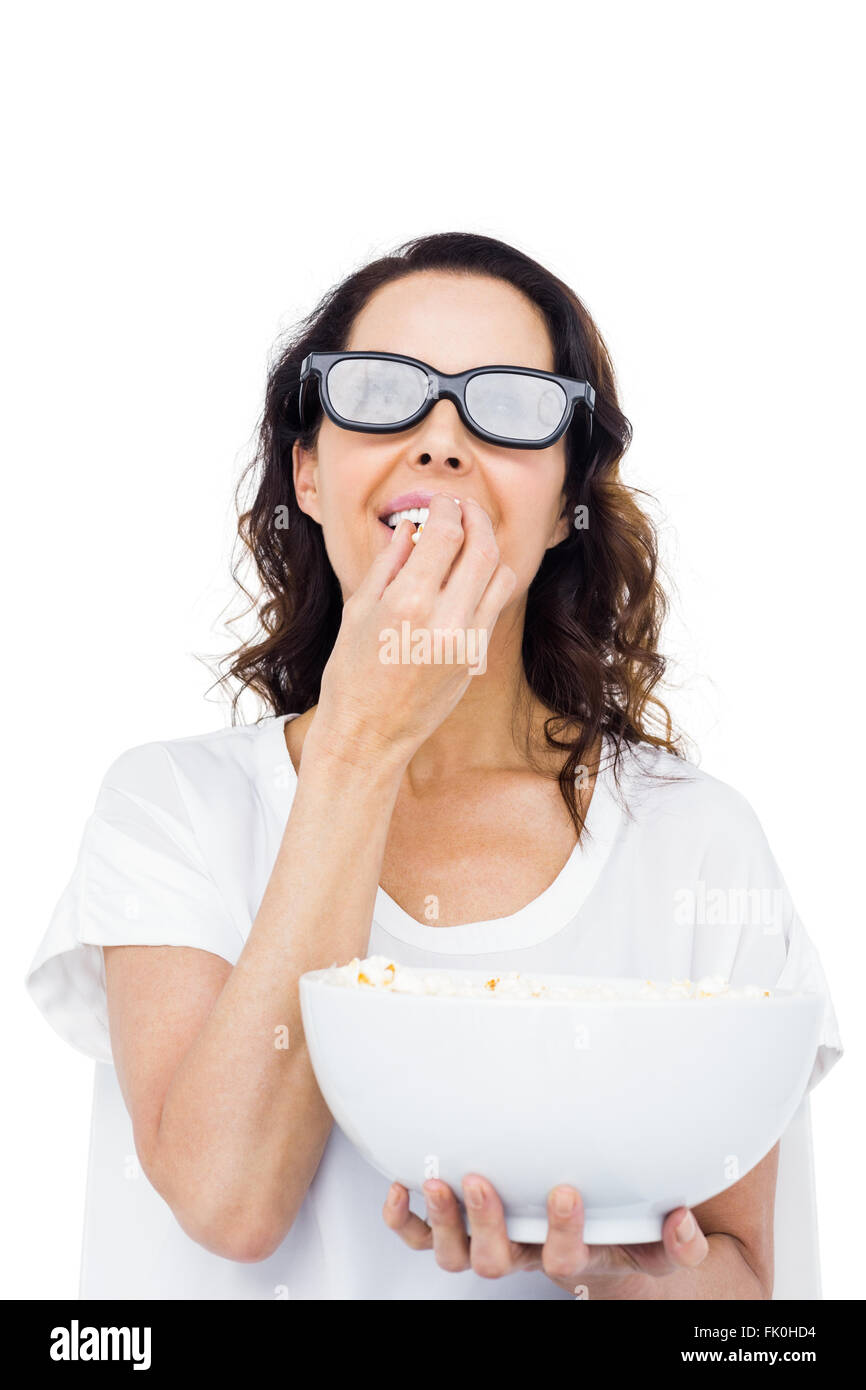 Pretty woman with 3D glasses eating popcorn Stock Photo