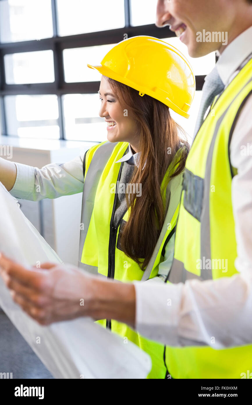 Architects looking at blueprint Stock Photo - Alamy