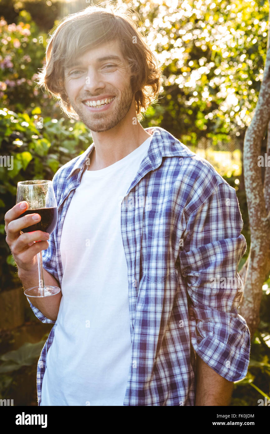 Smiling man with a glass of red wine Stock Photo - Alamy
