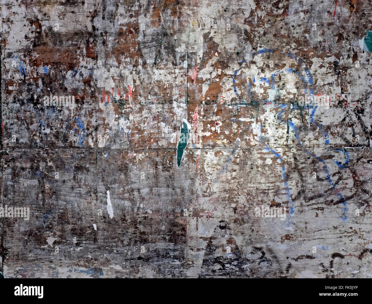 An abstract pattern of remnants of posters on a wall on Fourth Avenue in Greenwich Village in New York City Stock Photo