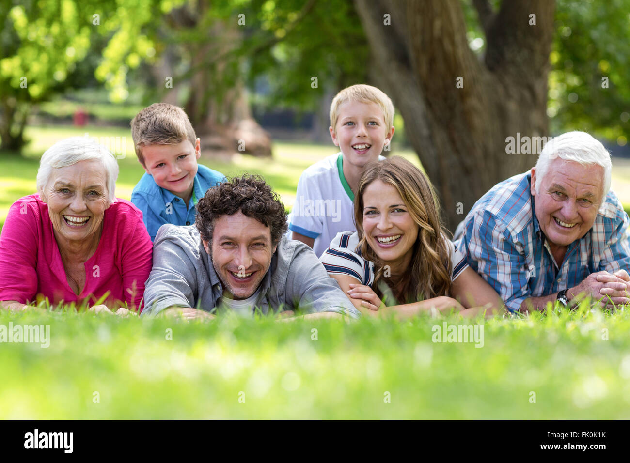 Smiling family lying in the grass Stock Photo