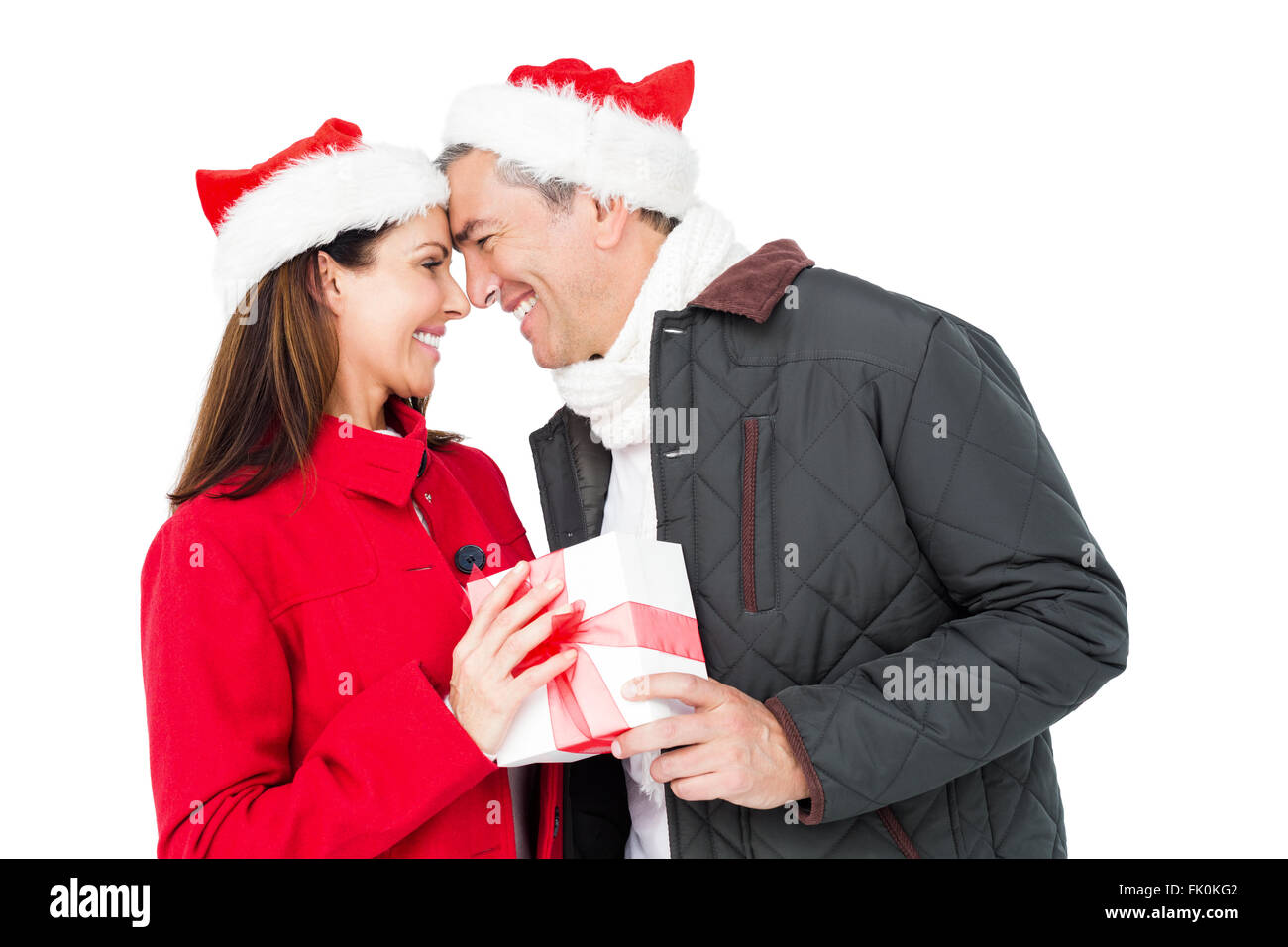 Festive couple exchanging christmas gift Stock Photo