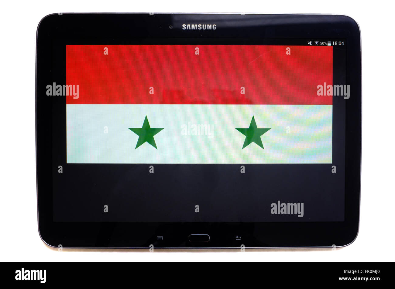The flag of Syria displayed on the screen of tablet photographed against a white background. Stock Photo