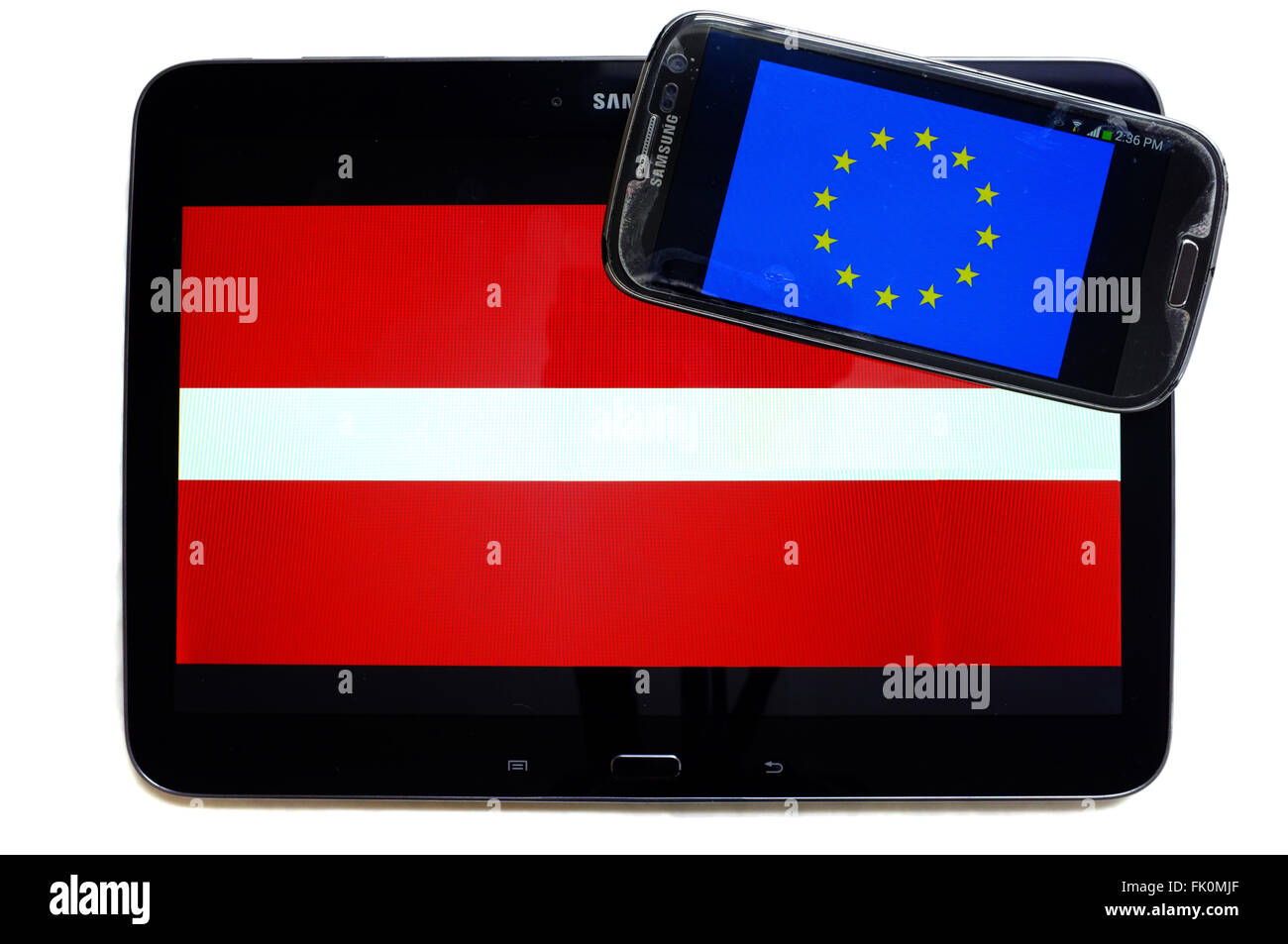 The EU flag on a smartphone screen displayed alongside the Latvian flag on a tablet screen. Stock Photo