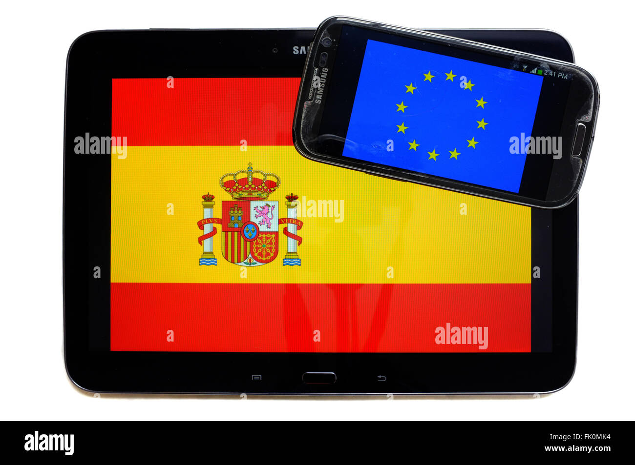 The flags of Spain and the EU displayed on the screens of a tablet and a smartphone against a white background. Stock Photo