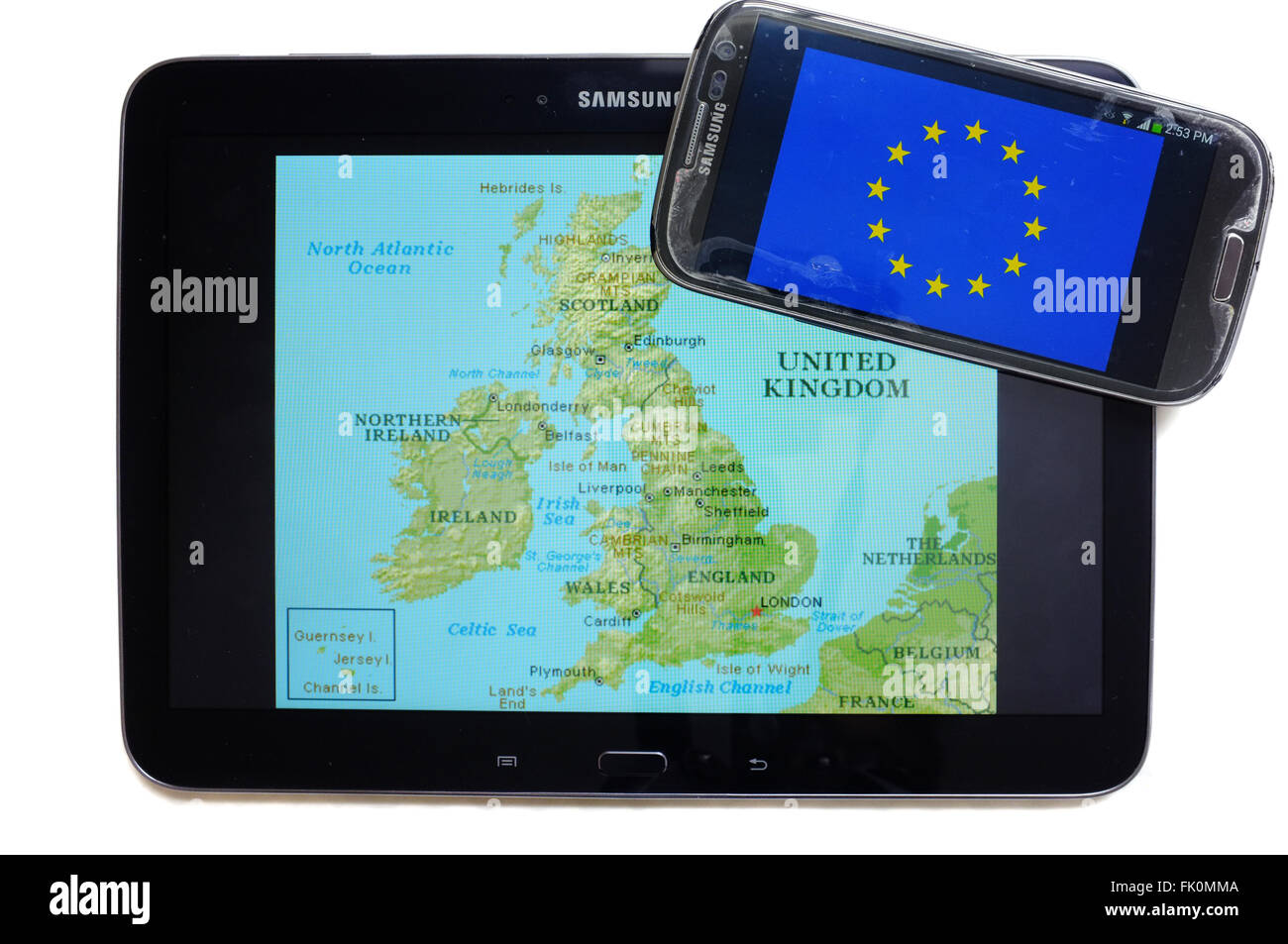 A map of the UK and the EU flag displayed on the screens of a tablet and a smartphone against a white background. Stock Photo