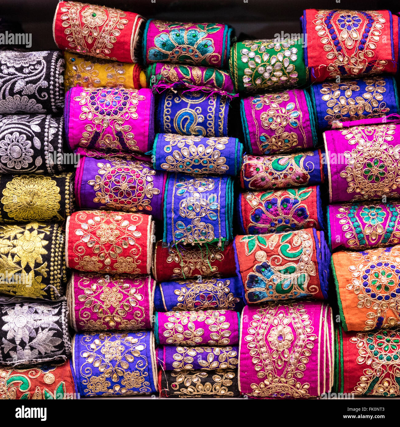 Brightly colored silver and gold embroidered ribbons for sale in notions shop in Hagi (nomadic) bazaar, Shiraz, Iran Stock Photo