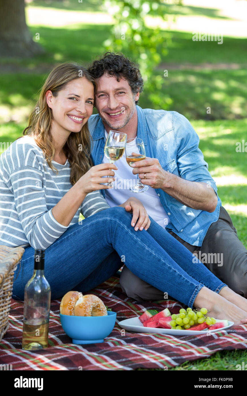 Couple having a picnic with wine Stock Photo - Alamy