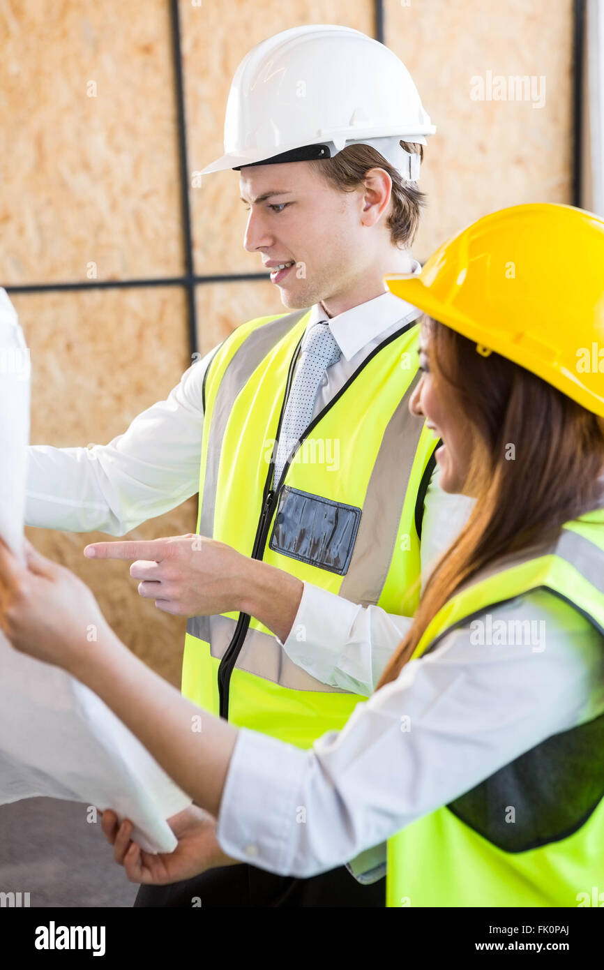 Architects looking at blueprint Stock Photo