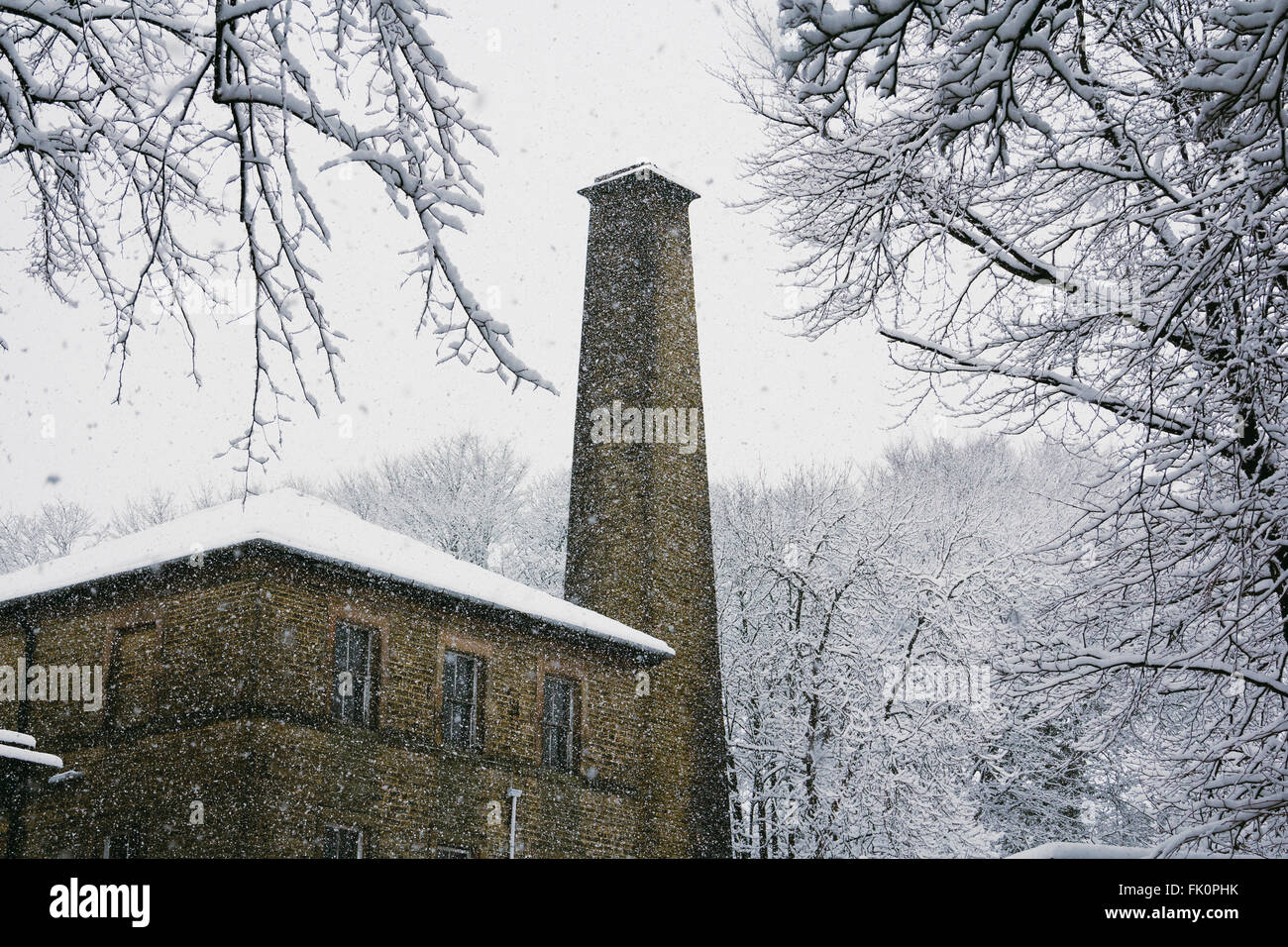 Old industrial building with tower in a snow storm. Buxton, England. Stock Photo