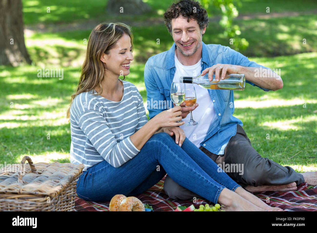 Couple having a picnic with wine Stock Photo - Alamy