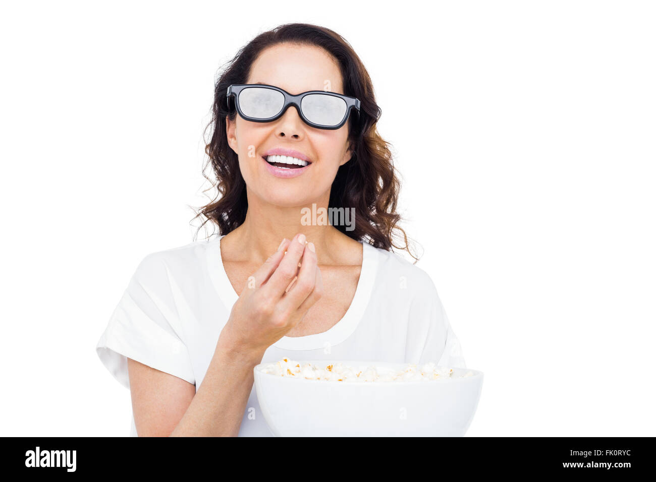 Pretty woman with 3D glasses eating popcorn Stock Photo