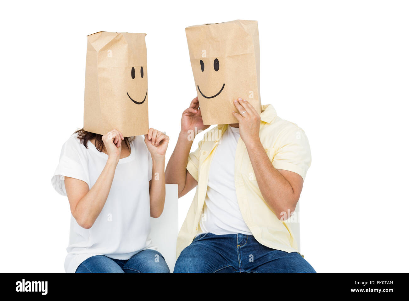 Couple covering their faces with paper bag Stock Photo