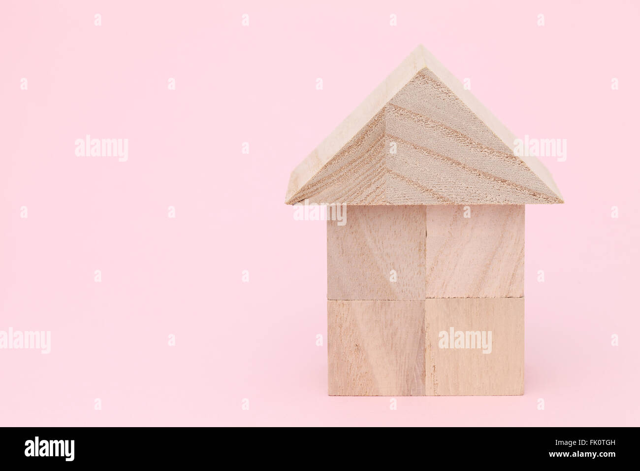 Wooden toy house with natural colored toy blocks Stock Photo Alamy