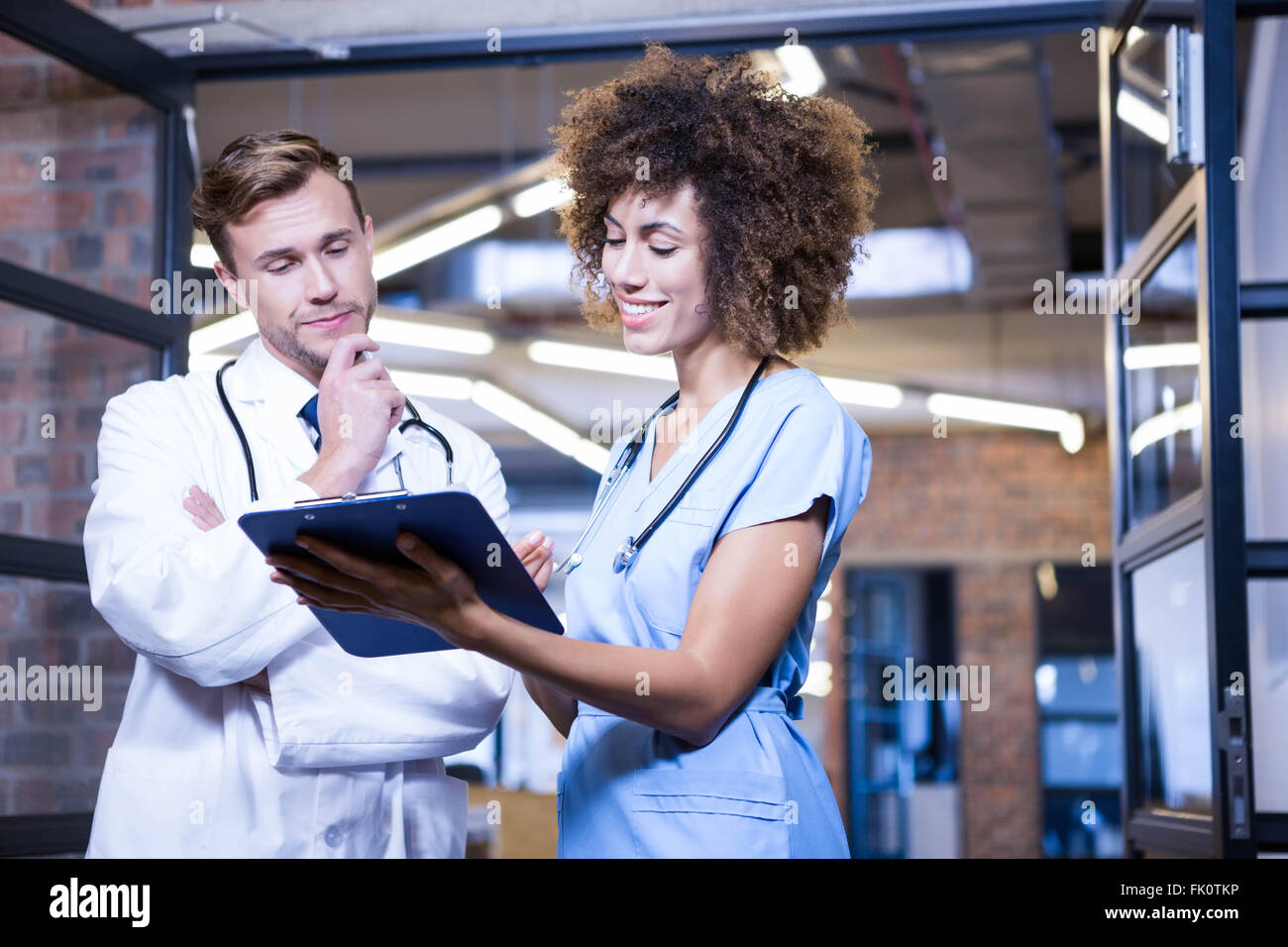 Doctors standing together clipboard hi-res stock photography and images ...