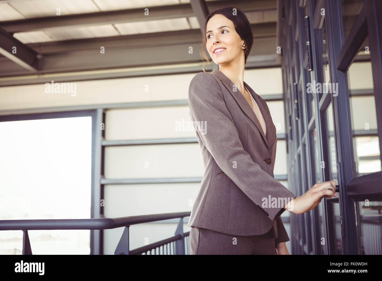 Young woman standing doorway office hi-res stock photography and images ...