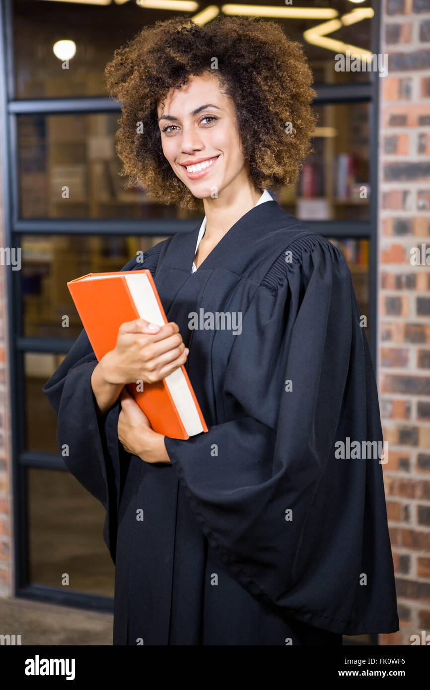 Lawyer standing near library with law book Stock Photo Alamy