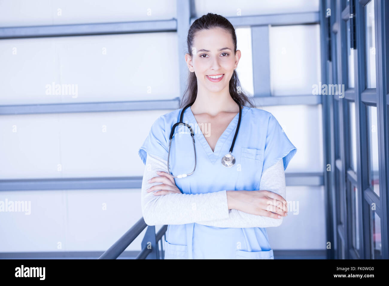 Female doctor standing with arms crossed Stock Photo - Alamy