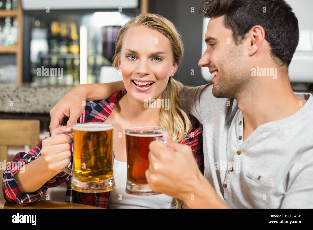 Couple toasting with beers Stock Photo