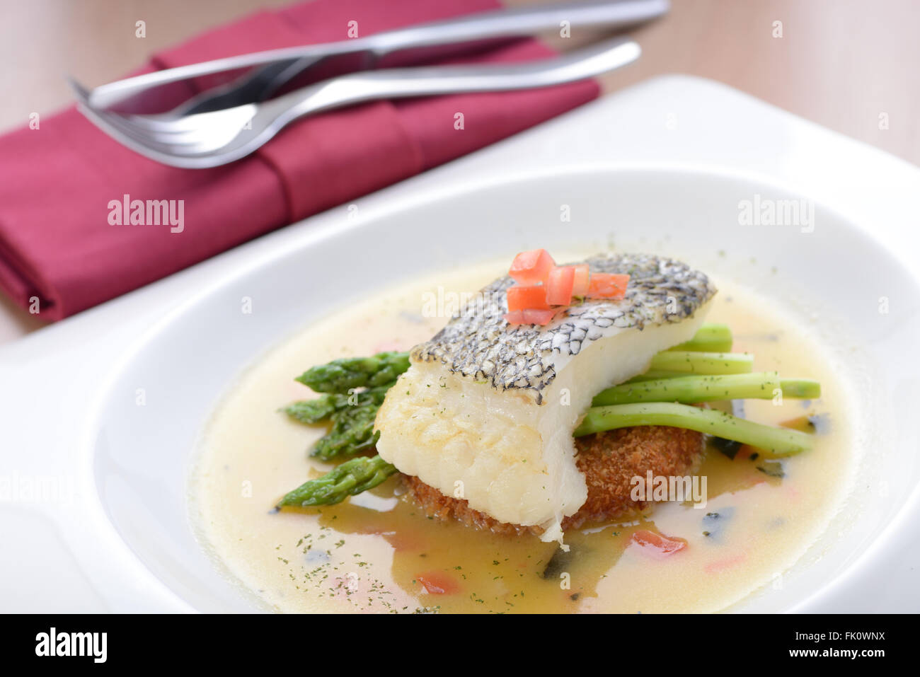 Braised cod fish on top of Asparagus Stock Photo Alamy