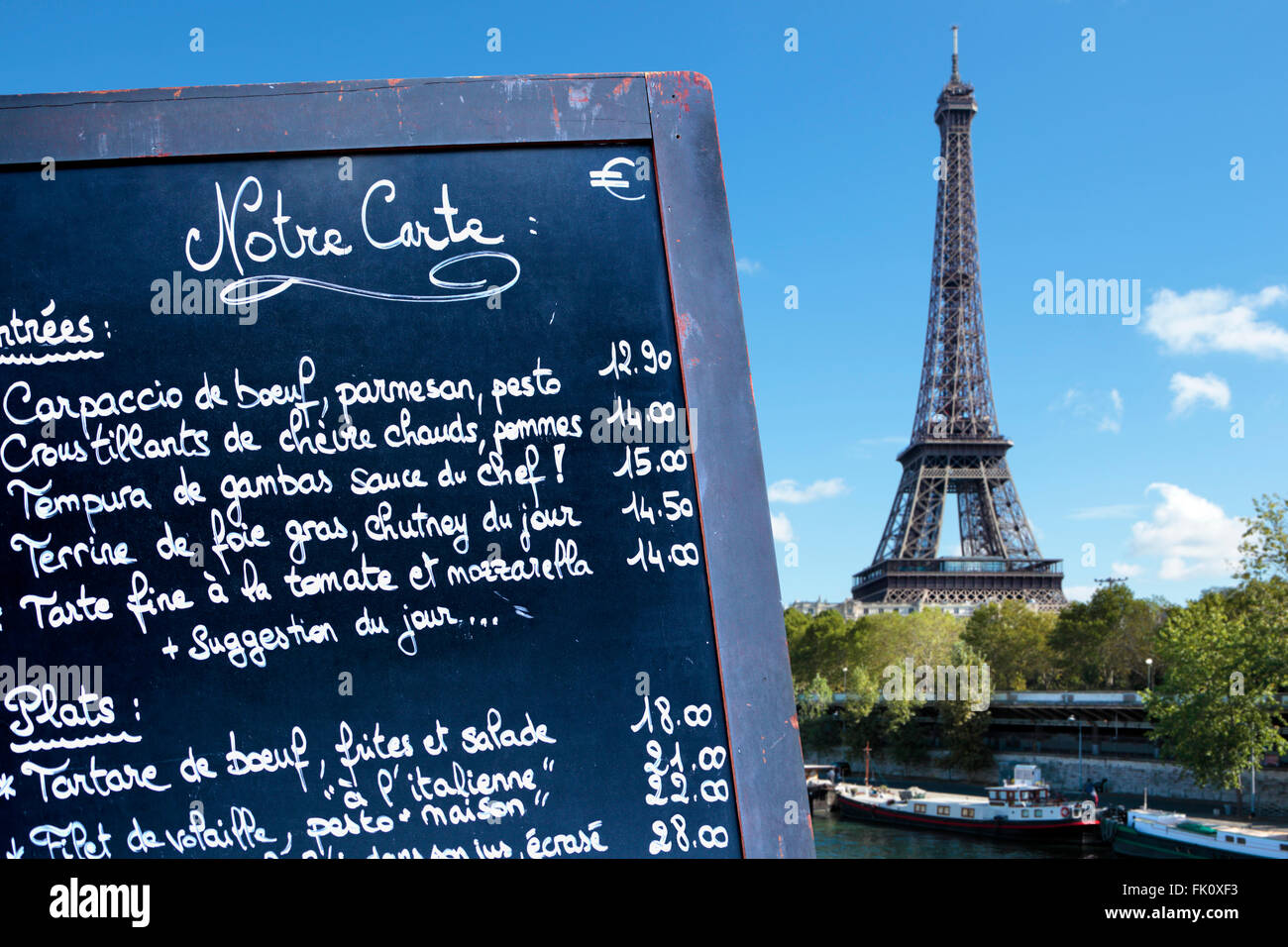 Paris france, french restaurant menu board with Eiffel Tower in the distance. Stock Photo