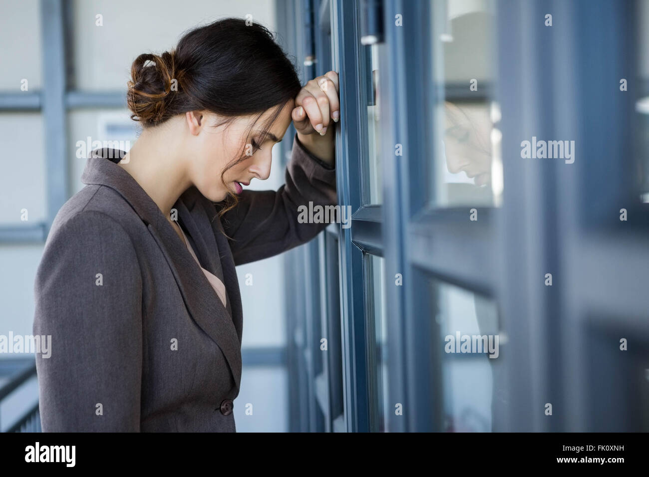 Tired businesswoman in office Stock Photo