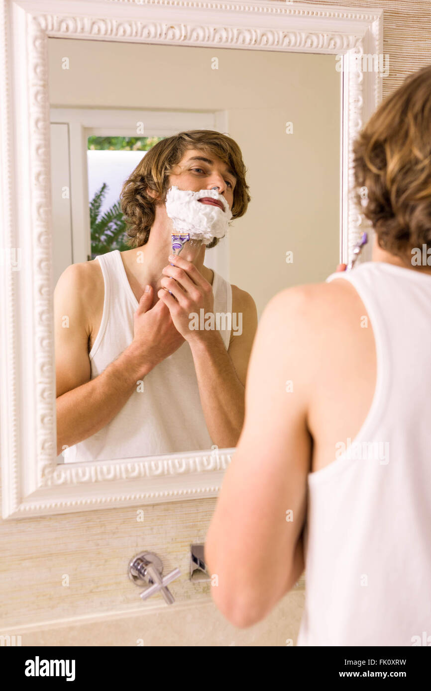Handsome man shaving in the bathroom Stock Photo Alamy