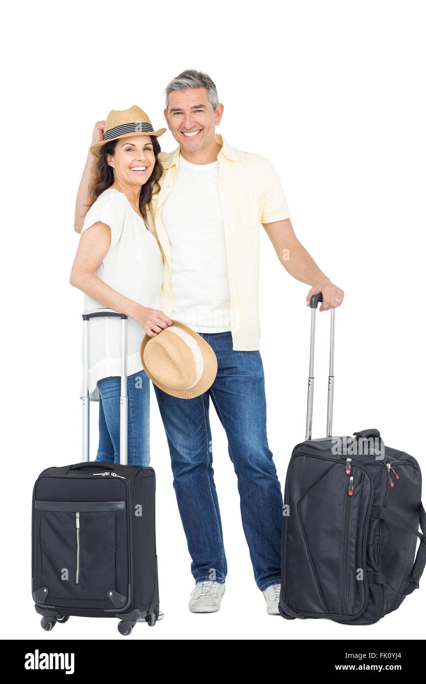 Happy couple in vacation with luggage Stock Photo