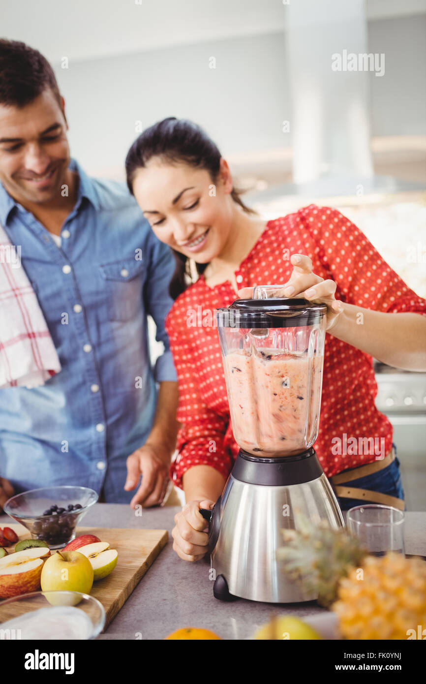 Smiling people preparing fruit juice Stock Photo Alamy