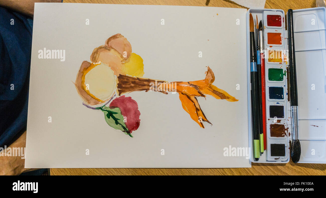 A watercolor painting and palette in a class for seniors at Garden