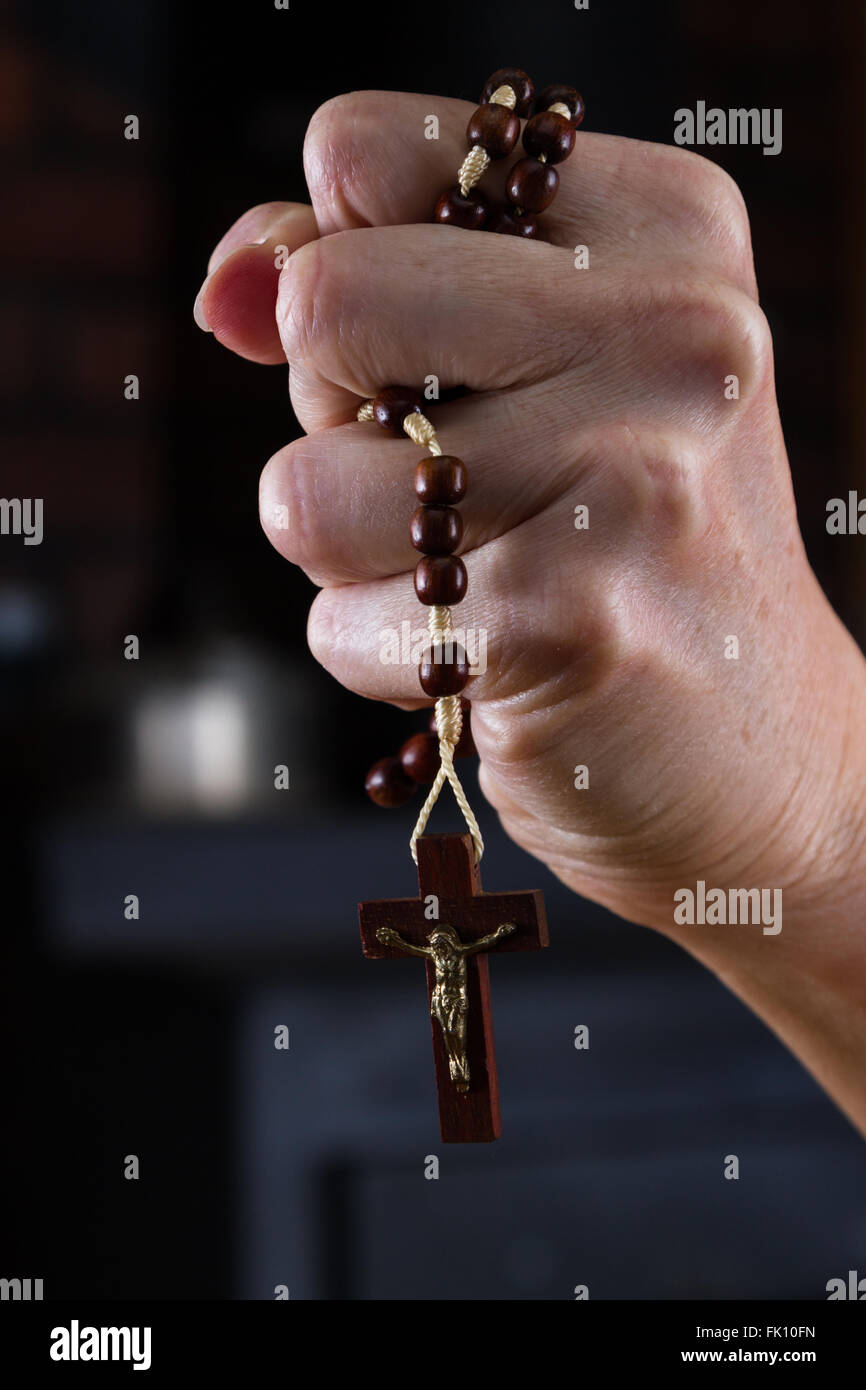 close up of a woman's hands holding rosary beads focused on the cross Stock  Photo - Alamy