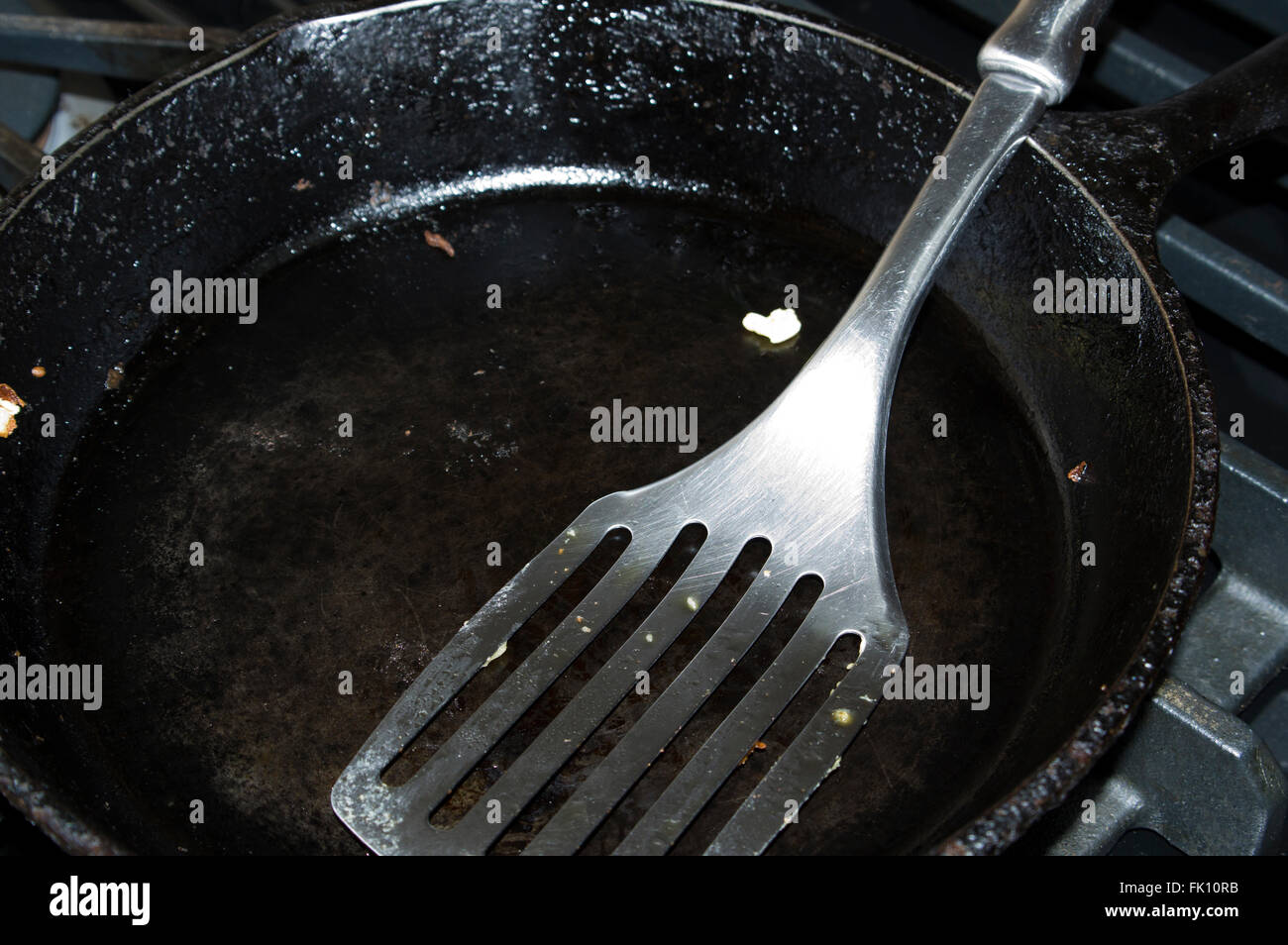 cast iron frying pan, spatula Stock Photo Alamy