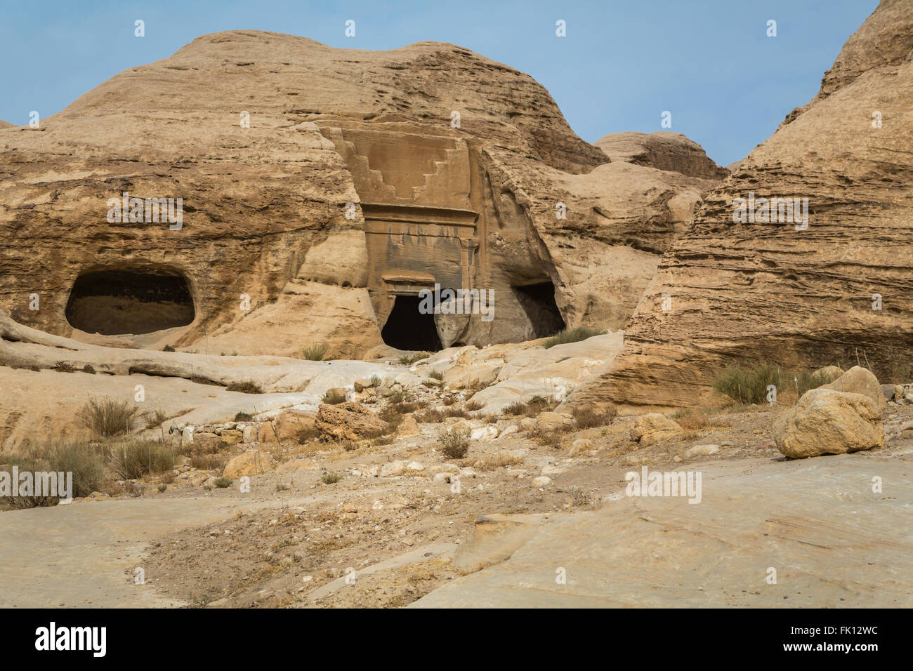 Carved tombs and caves in the Siq passage to the entrance of Petra, Hashemite Kingdom of Jordan, Middle East. Stock Photo