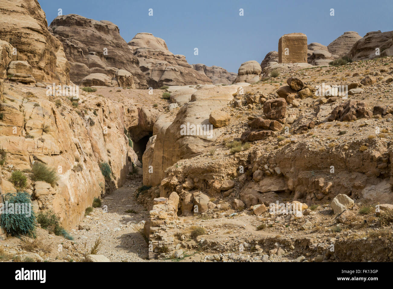 Carved tombs and caves in the Siq passage to the entrance of Petra, Hashemite Kingdom of Jordan, Middle East. Stock Photo