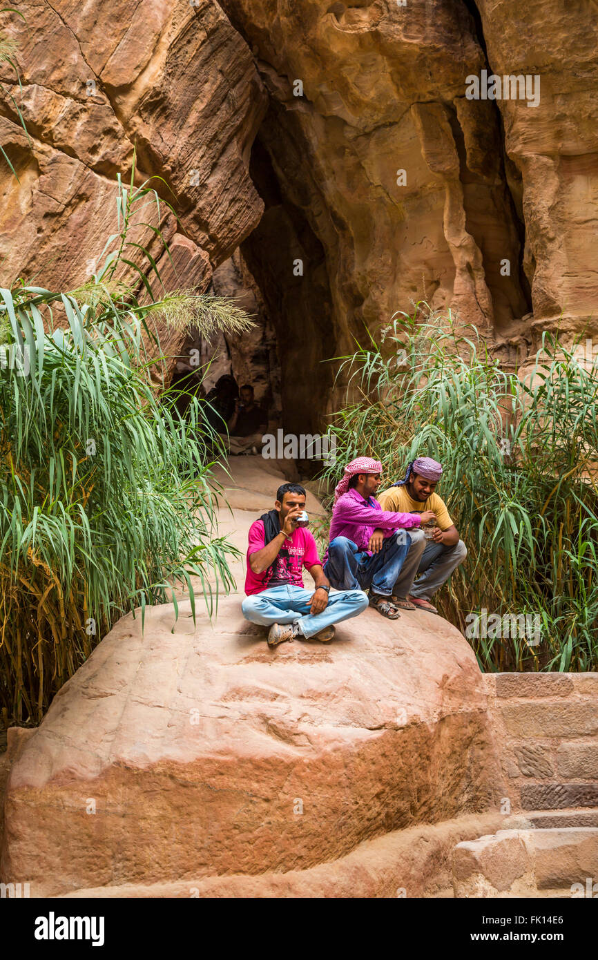 Jordanian guides in the narrow Siq passage to the entrance of Petra, Hashemite Kingdom of Jordan, Middle East. Stock Photo