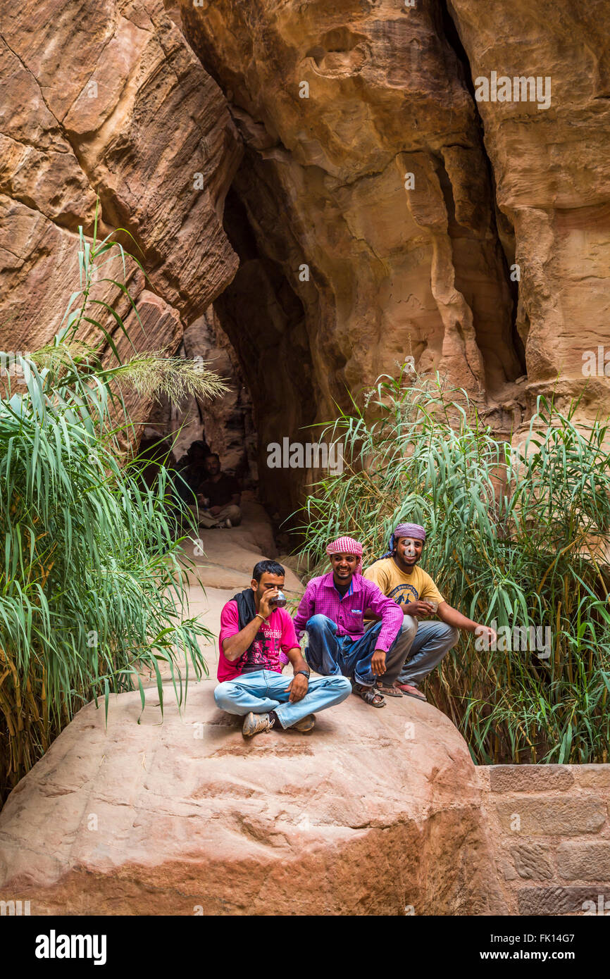 Jordanian guides in the narrow Siq passage to the entrance of Petra, Hashemite Kingdom of Jordan, Middle East. Stock Photo