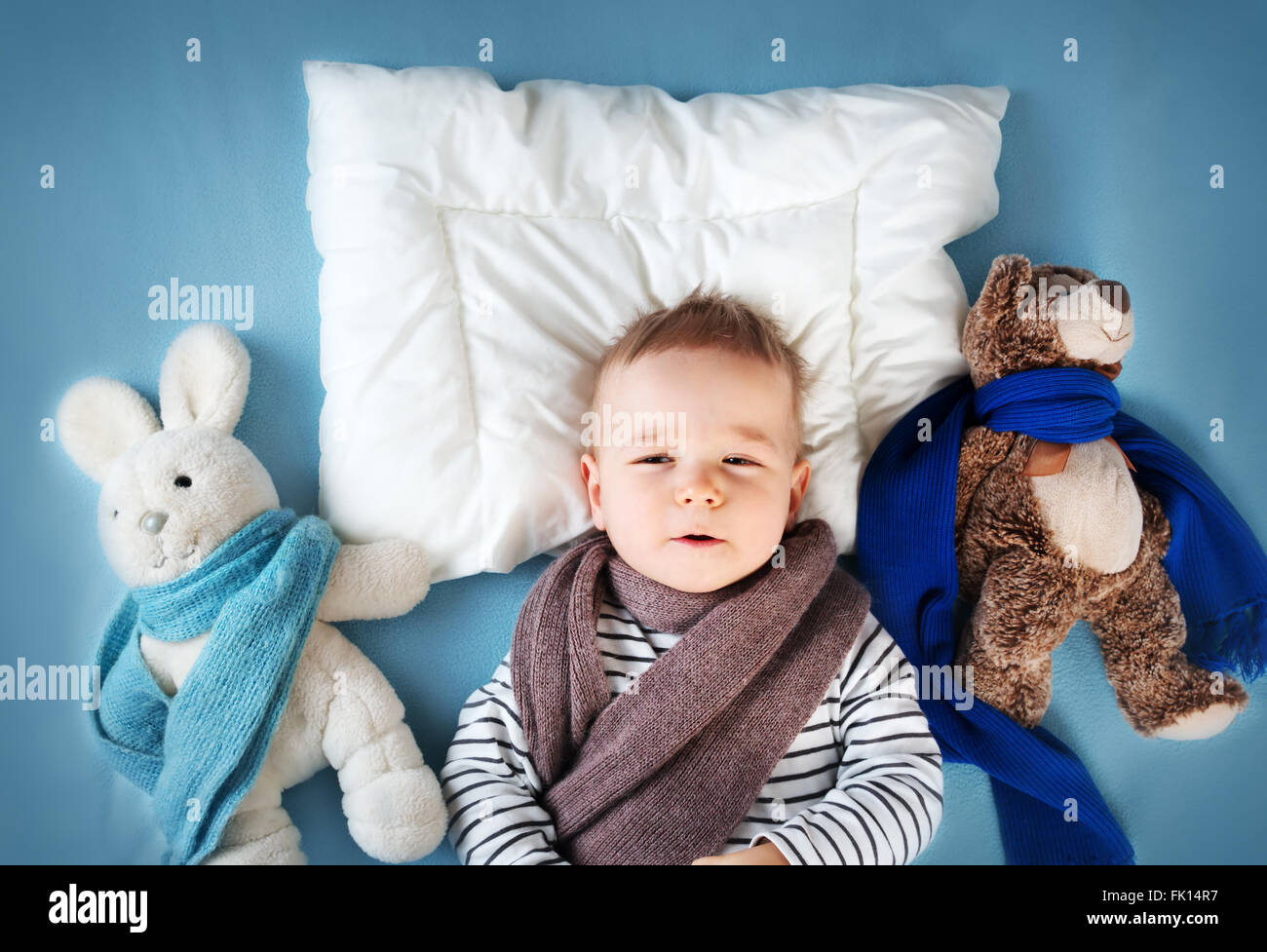 Ill boy lying in bed Stock Photo