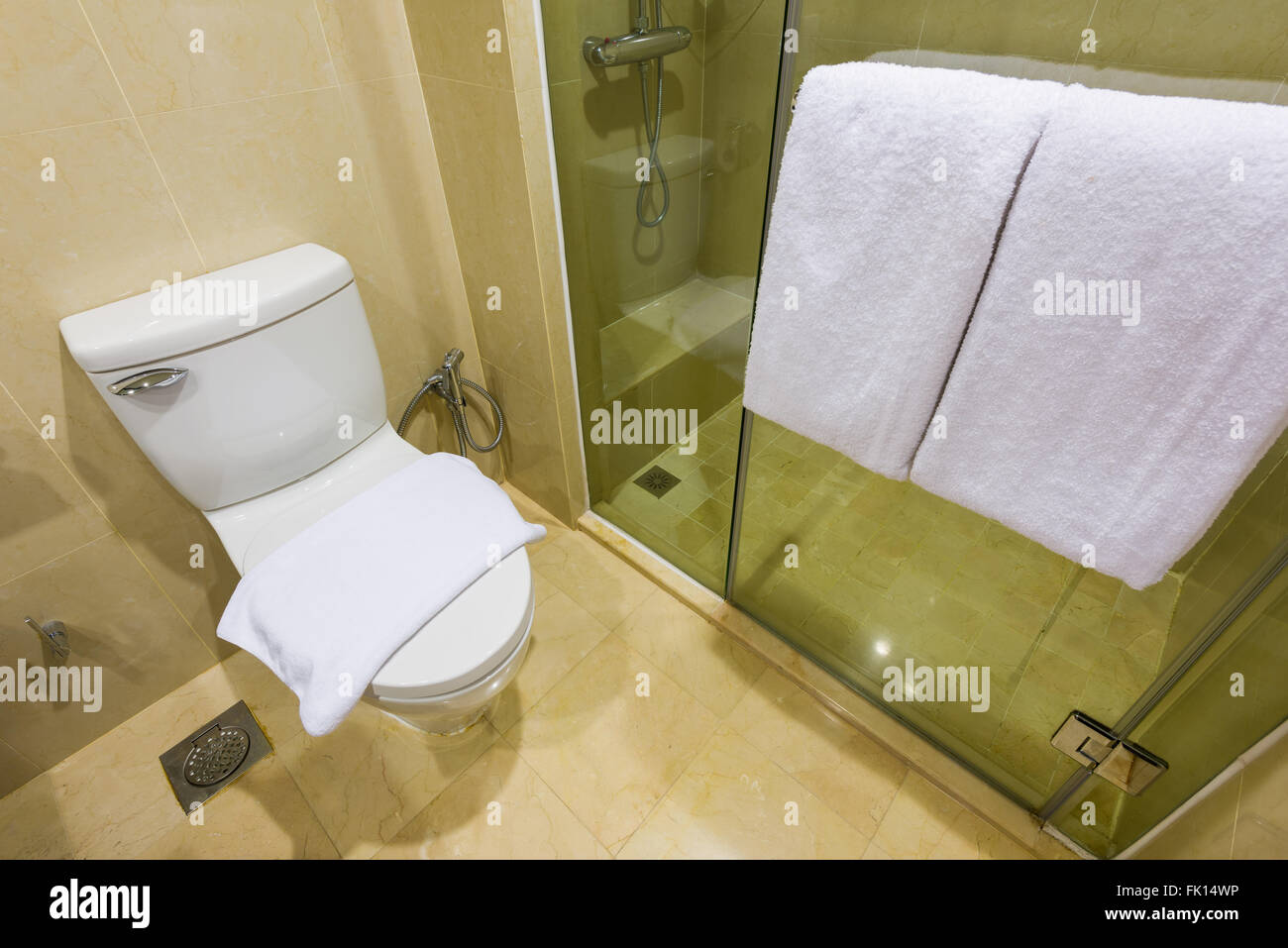 Generic hotel bathroom and toilet with fresh towels. Stock Photo