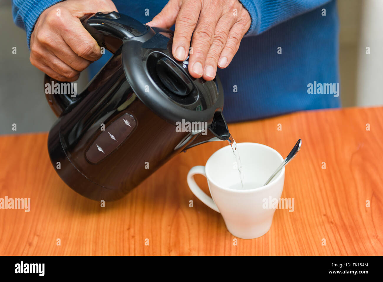 Pouring hot water from flask into cup Stock Photo Alamy