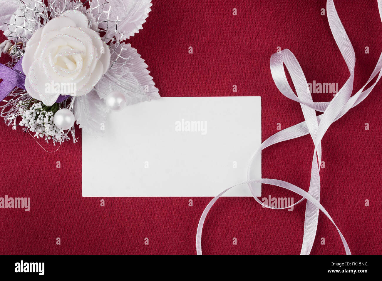 Background with  flower and empty tag for your text on red silk  background.  Square image. Stock Photo